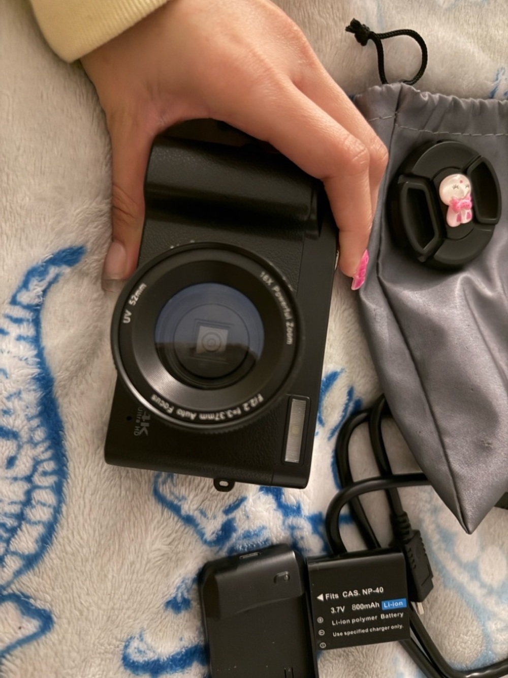 Black Compact Digital Camera with Lens Cap and Charger